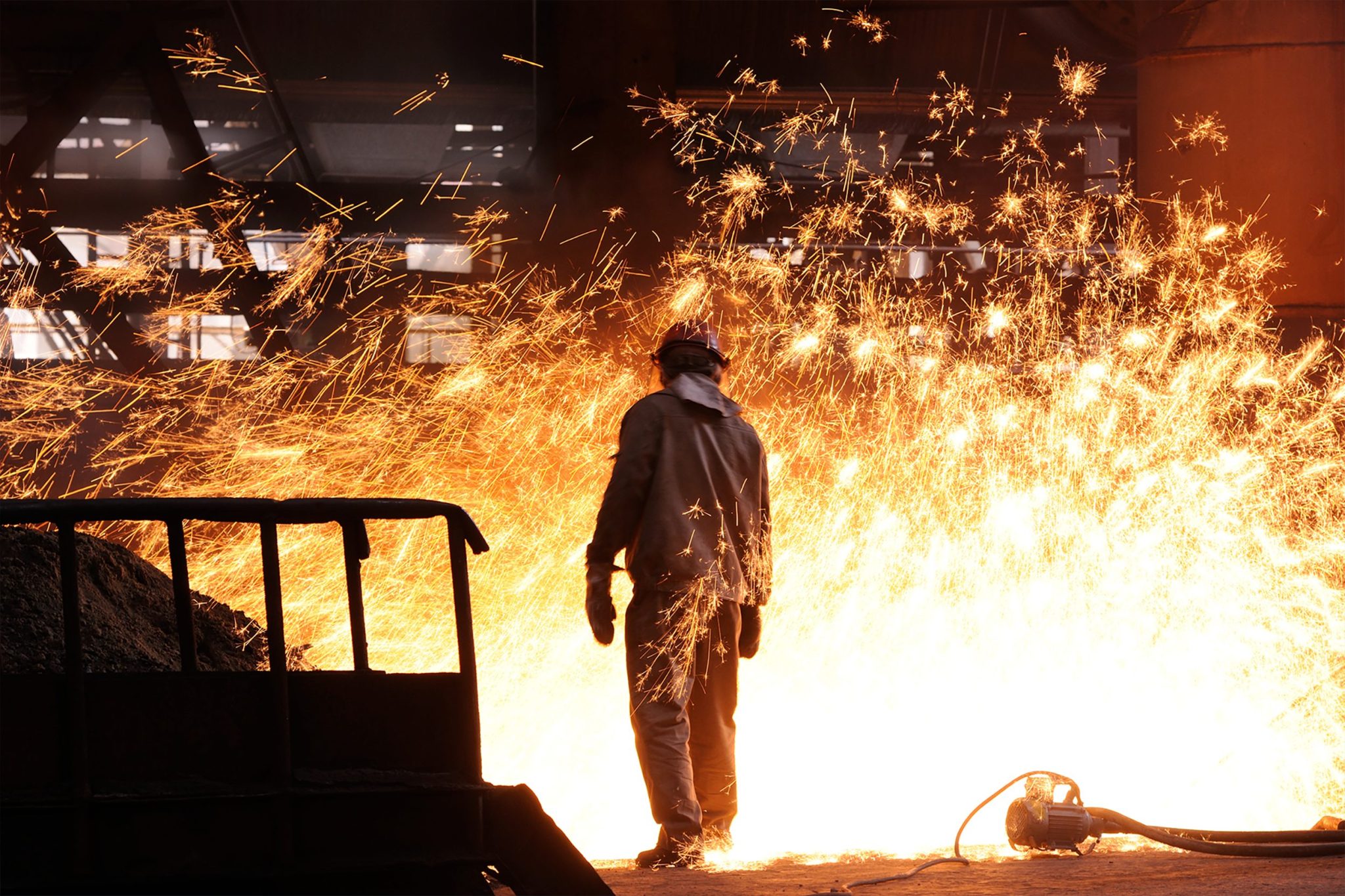 man standing near flames representing Lastan’s heat‑resistant material